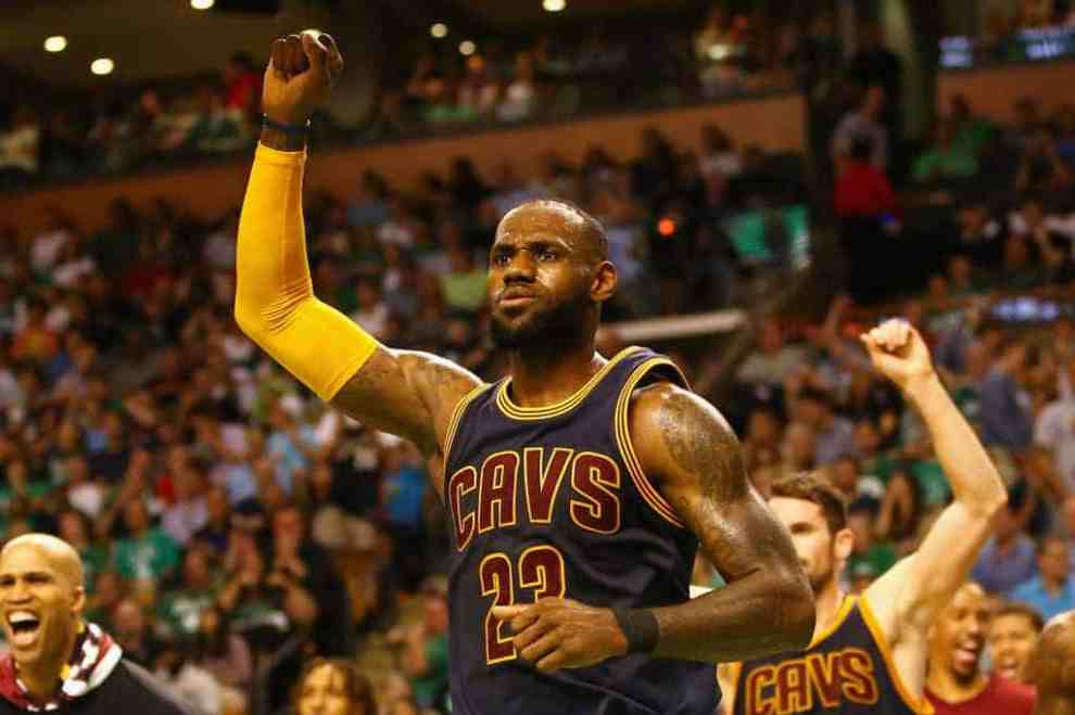 LeBron James in Cleveland Cavalier's #23 Jersey with right arm raised during game