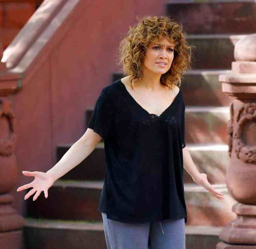 Jennifer Lopez in front of red brick steps