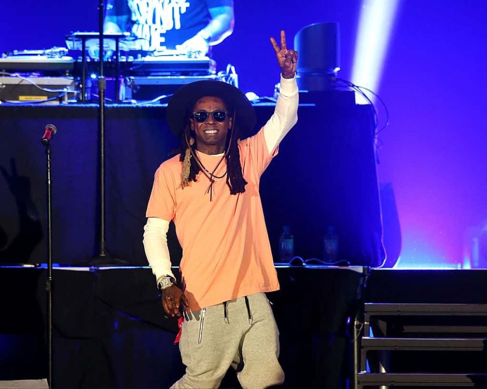 Lil Wayne performing and pointing up with left hand