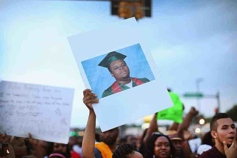 Protesters holding a photo of Mike Brown