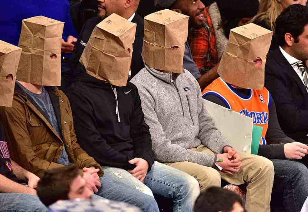 Knicks fans attending game with paper bags over their faces