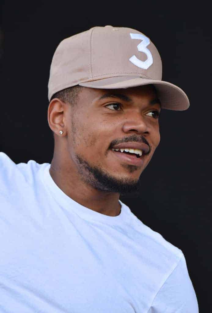 Chance the Rapper wearing beige baseball hat with white 3
