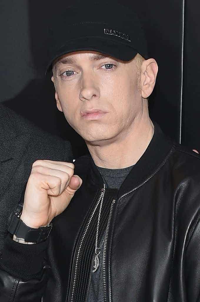 Eminem in all black with right hand in fist
