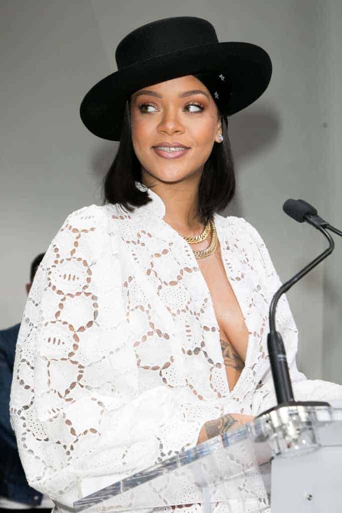 Rihanna wearing all white lace Dior dress and black hat at LVMH Young Fashion Designer’s 2017 prize awards