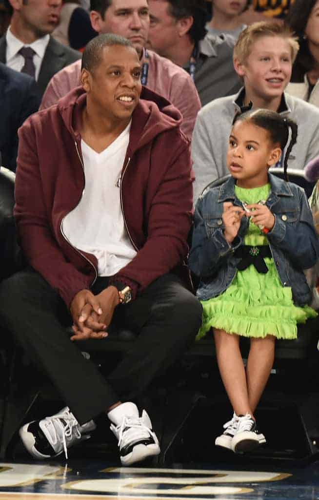 Jay Z sitting with Blue Ivy at a basketball game