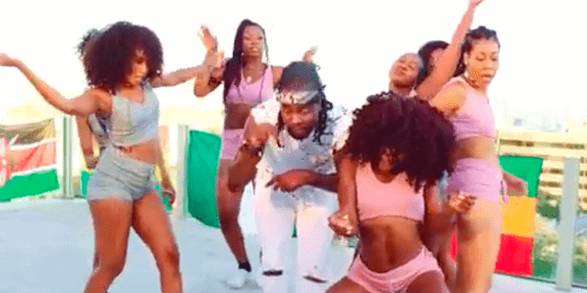 Screenshot from video of Wale surrounded by women of color