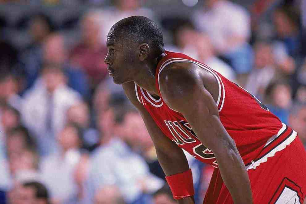 Michael Jordan #23 of the Chicago Bulls rests on the court during a game in 1988