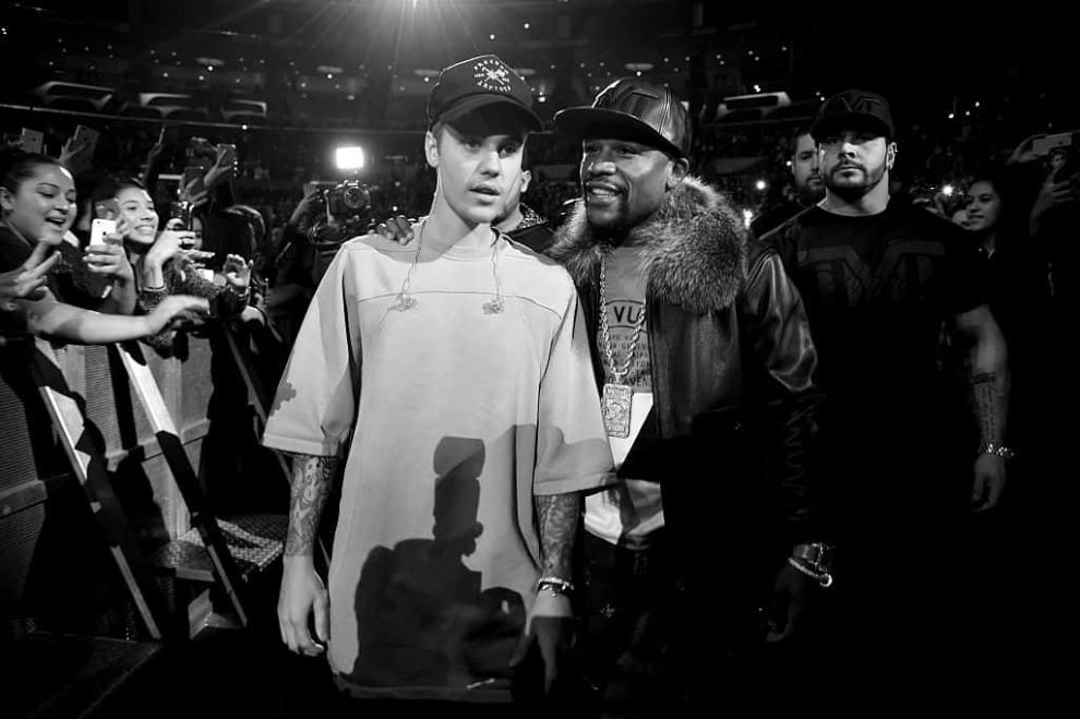 Justin Bieber and Floyd Mayweather walk onstage during An Evening With Justin Bieber at Staples Center on November 13