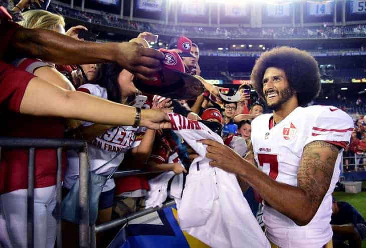 Colin Kapernick in #7 of San Fransisco 49ers signs autographs for fans