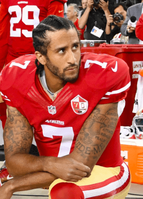 Colin Kapernick in #7 of San Fransisco 49ers sitting on bench during a game