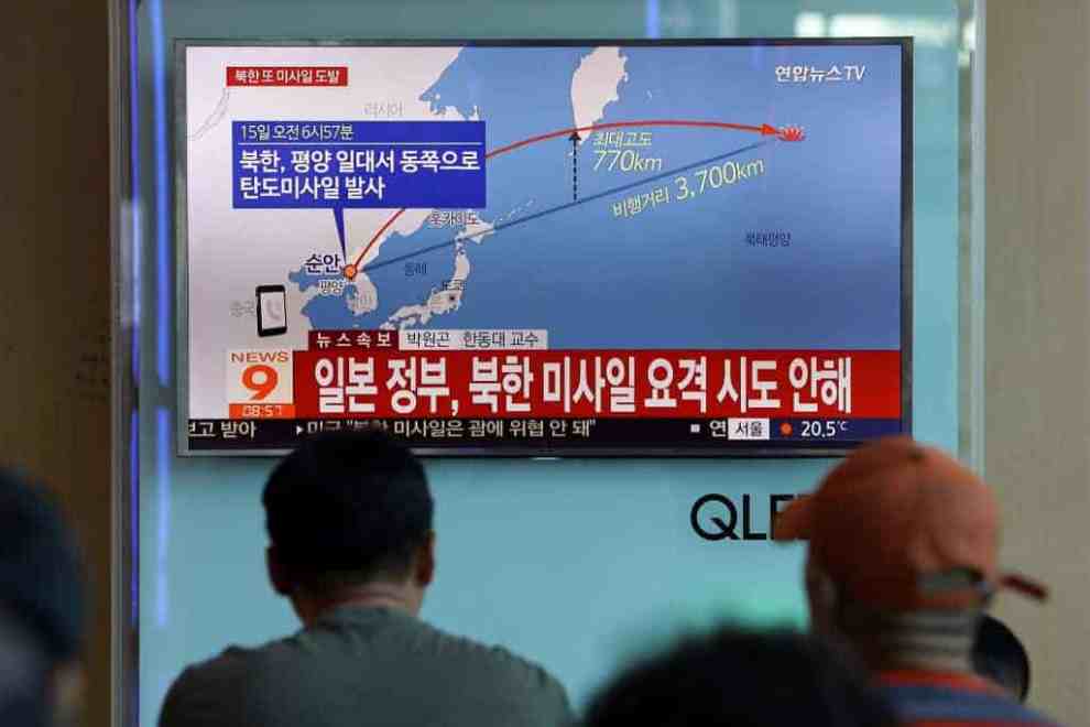 People watch a television broadcast reporting the North Korean missile launch at the Seoul Railway Station on September 15