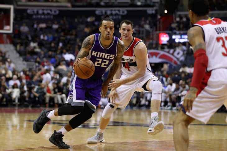 Matt Barnes  #22 of the Sacramento Kings dribbles the ball in front of Jason Smith #14 of the Washington Wizards