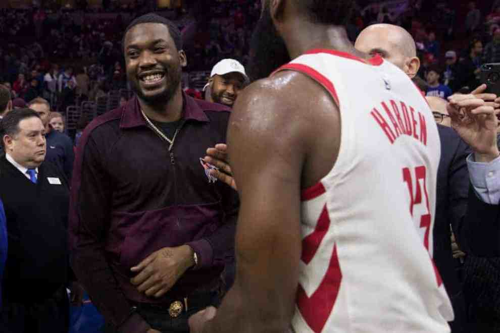 Meek Mill talks to James Harden #13 of the Houston Rockets after the game against the Philadelphia 76ers