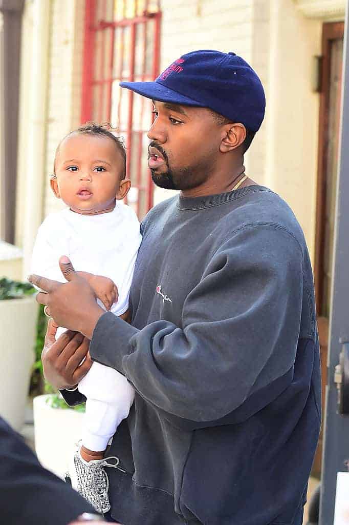 Kanye West with Saint West walking in Soho on October 6