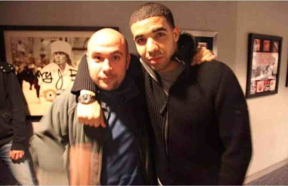 Drake with arm around Rosenberg in Hot 97 Studios