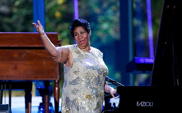 Aretha Franklin performing in front of piano