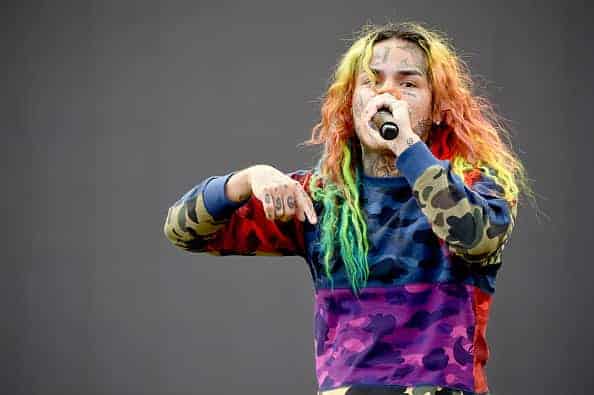 Tekashi 69 performing on stage.