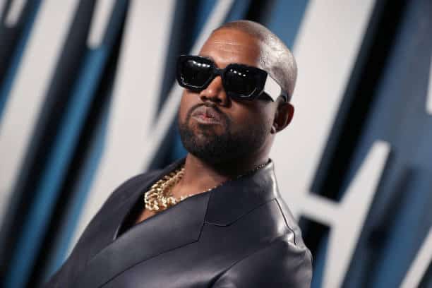 Kanye West wearing glasses and all black
