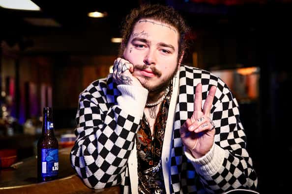 Post Malone behind the scenes before his Bud Light Dive Bar Tour show in Nashville giving peace sign
