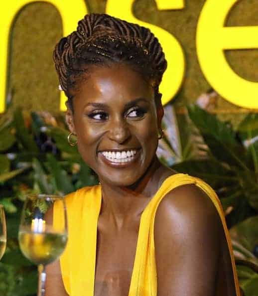 Issa Rae with a glass of white wine at Insecure event