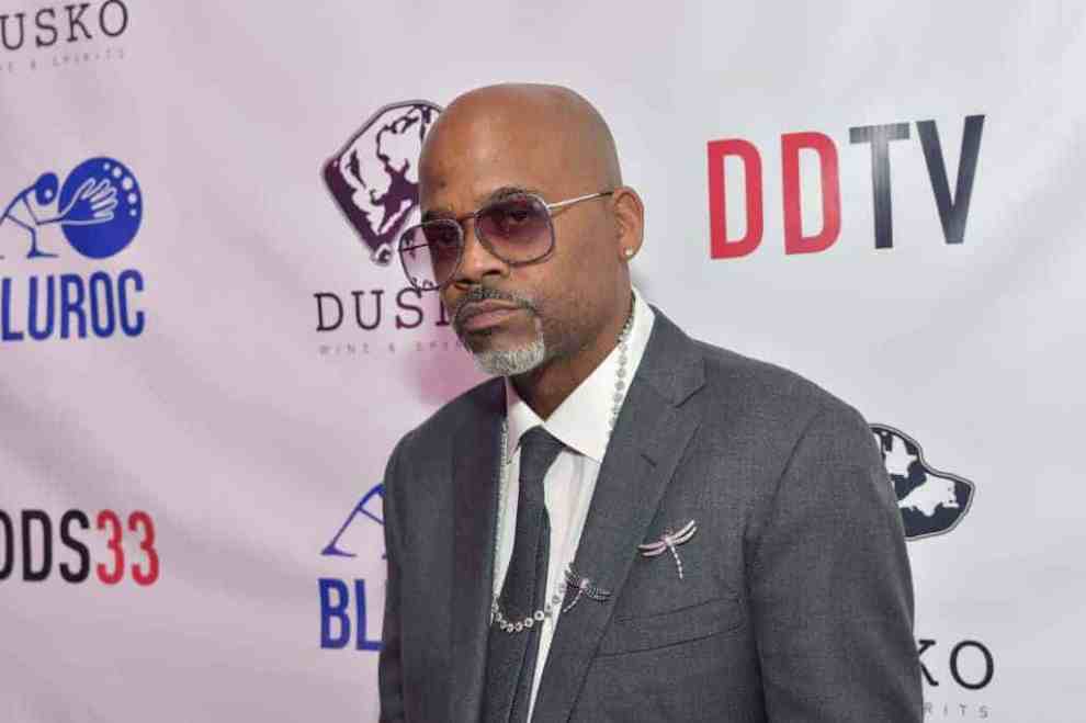 Damon Dash wearing a suit and glasses