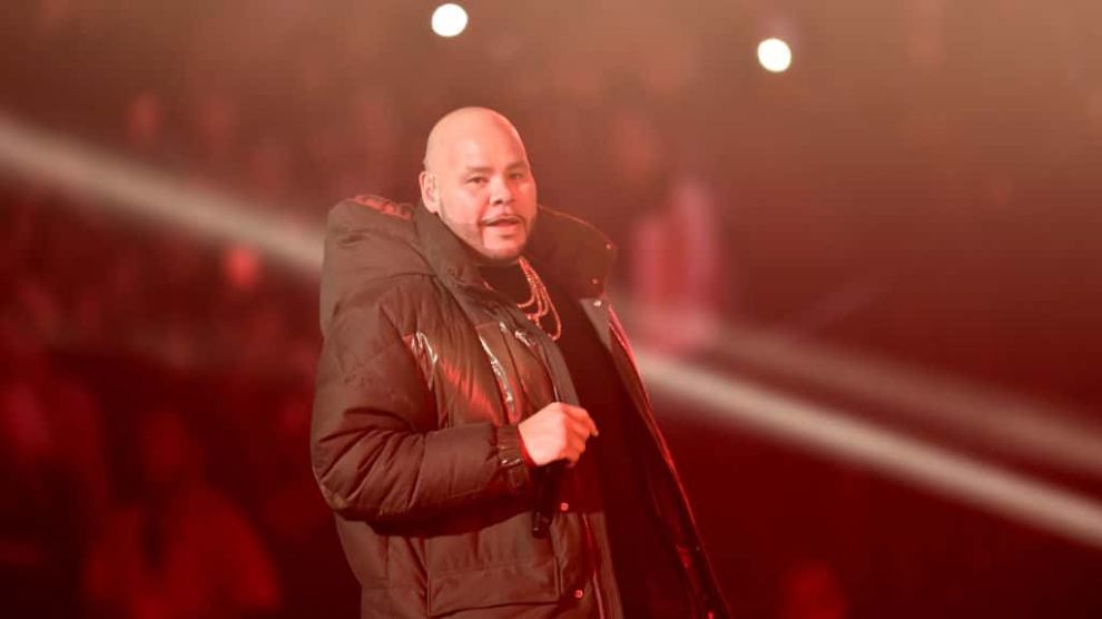Fat Joe wearing a sky blue suit smiling at the camera|