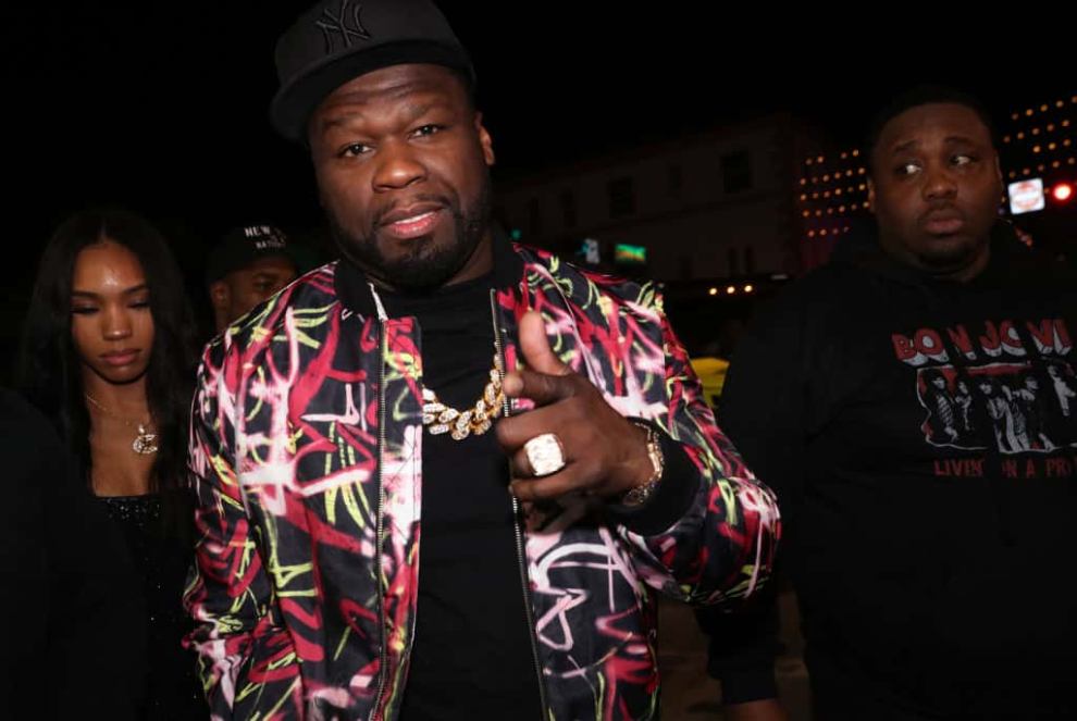 50 Cent wearing a multi-colored jacket