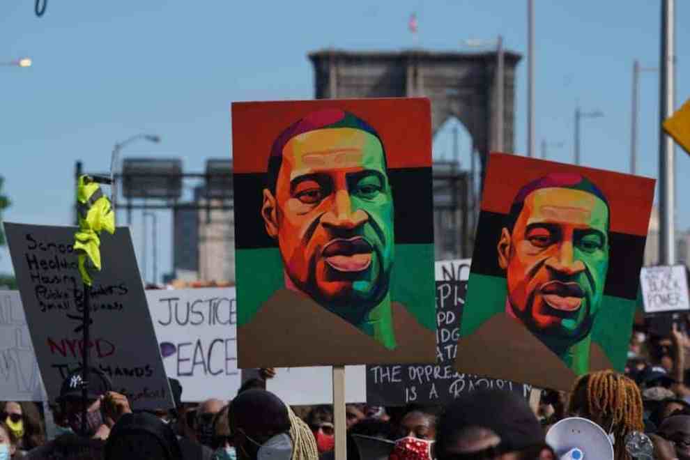 TOPSHOT - Protesters march across the Brooklyn Bridge over the death of George Floyd by Minneapolis Police during a Juneteenth rally in New York on June 19