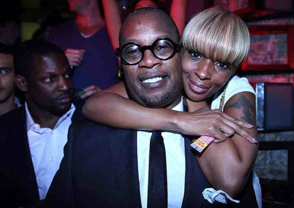Mary J. Blige and Andre Harrell smiling at the camera