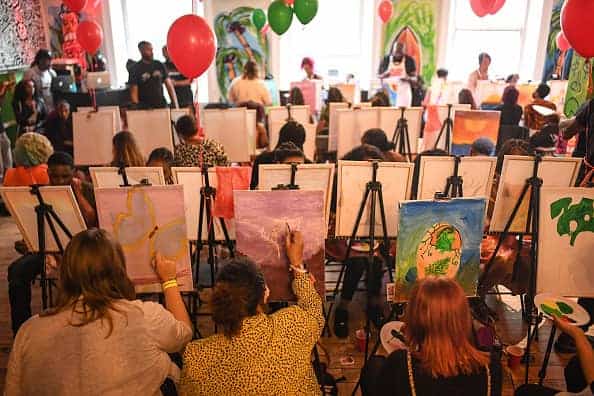 People take part in a 'Sip n Stroke' painting and drinking event on September 12
