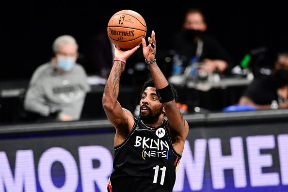 Kyrie Irving #11 of the Brooklyn Nets attempts a jump shot against the Milwaukee Bucks in Game Two of the Second Round of the 2021 NBA Playoffs at Barclays Center on June 07