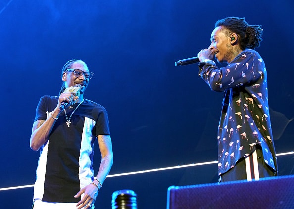 Recording artists Snoop Dogg (L) and Wiz Khalifa perform onstage at night one of the 2017 BET Experience STAPLES Center Concert