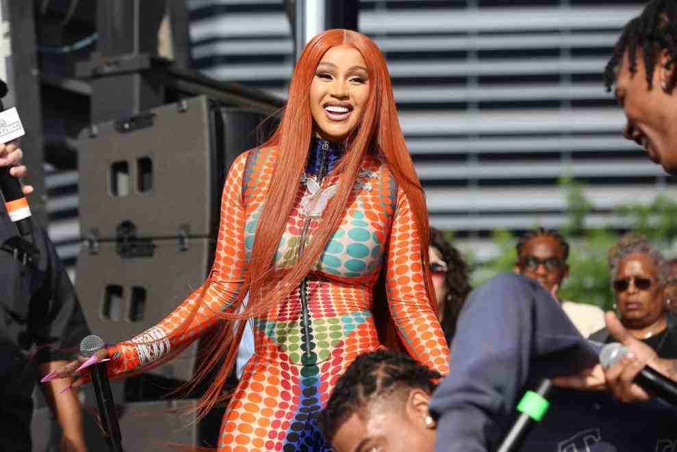 Cardi B. wearing orange on stage