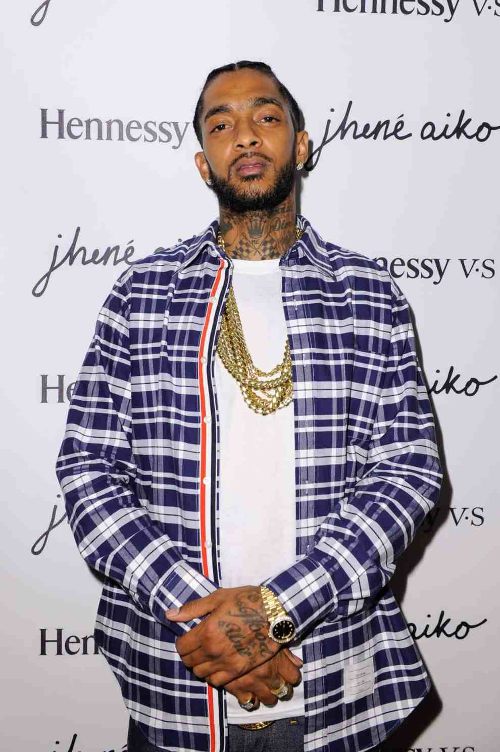 Nipsey Hussle wearing blue plaid shirt