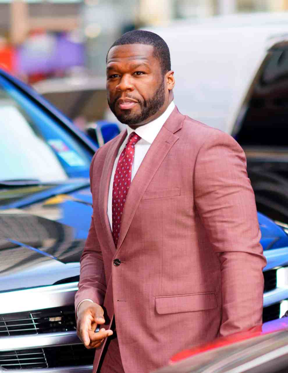 50 Cent wearing a red suit