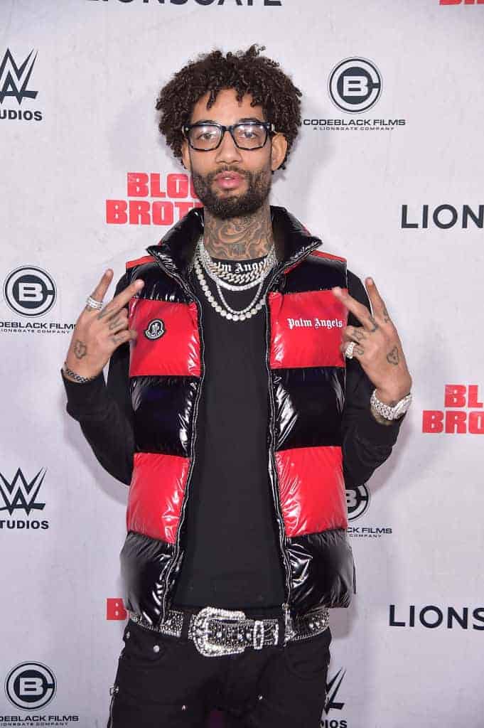 PnB Rock wearing a red and black jacket
