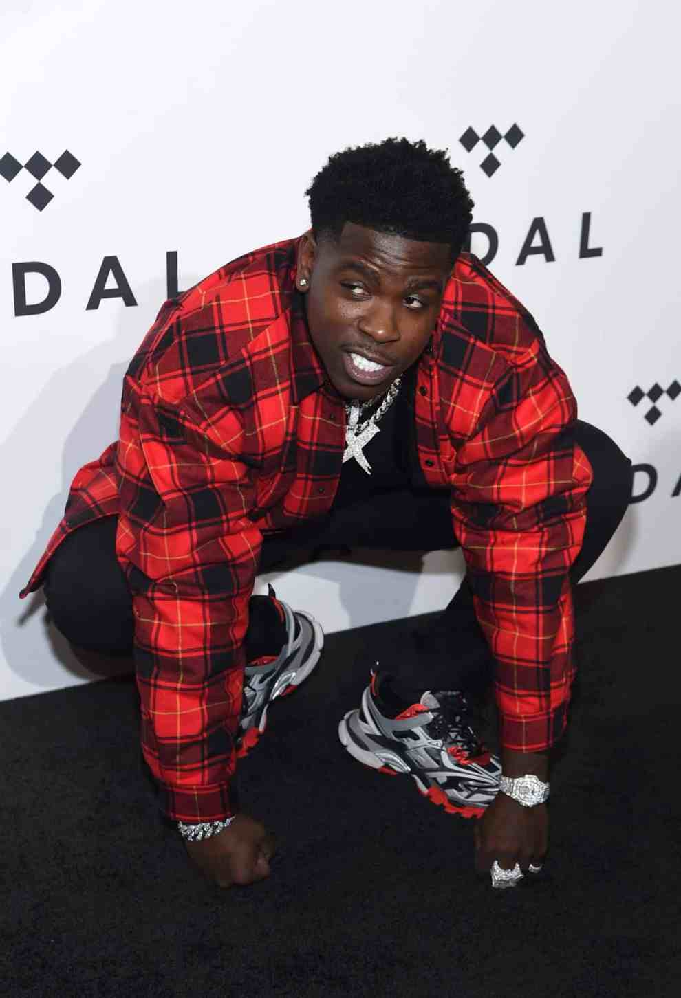 Casanova wearing a red and black shirt