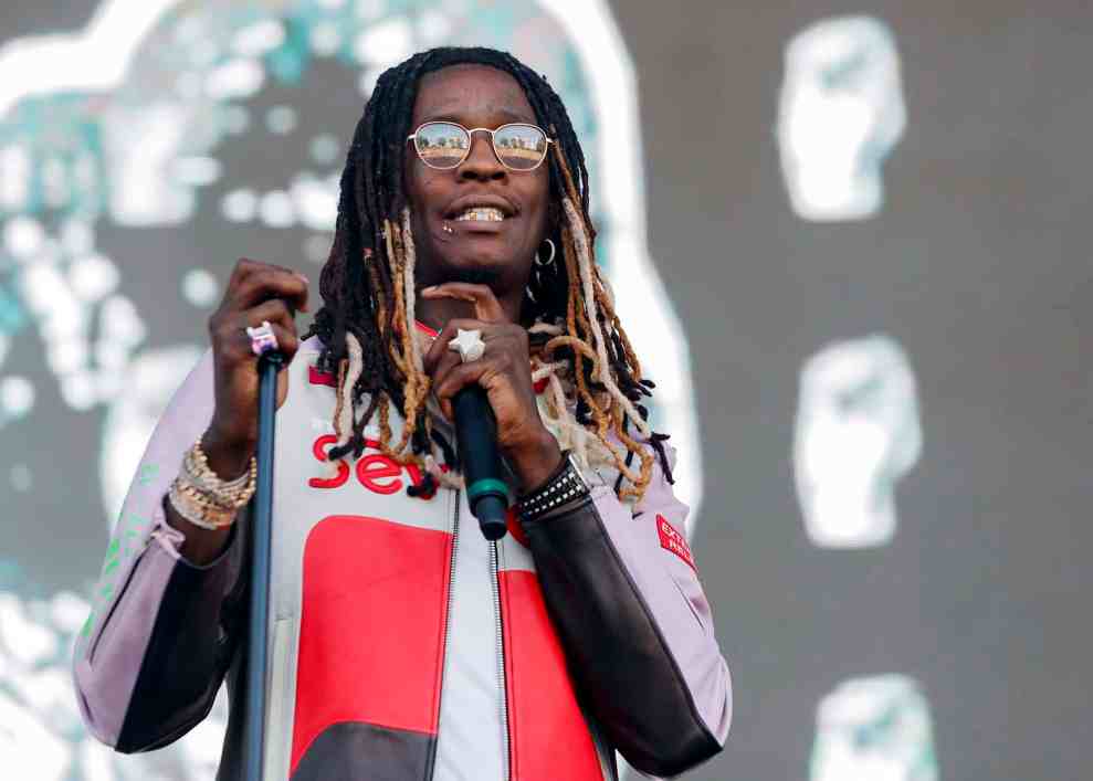 Young Thug wearing red and black jacket on stage