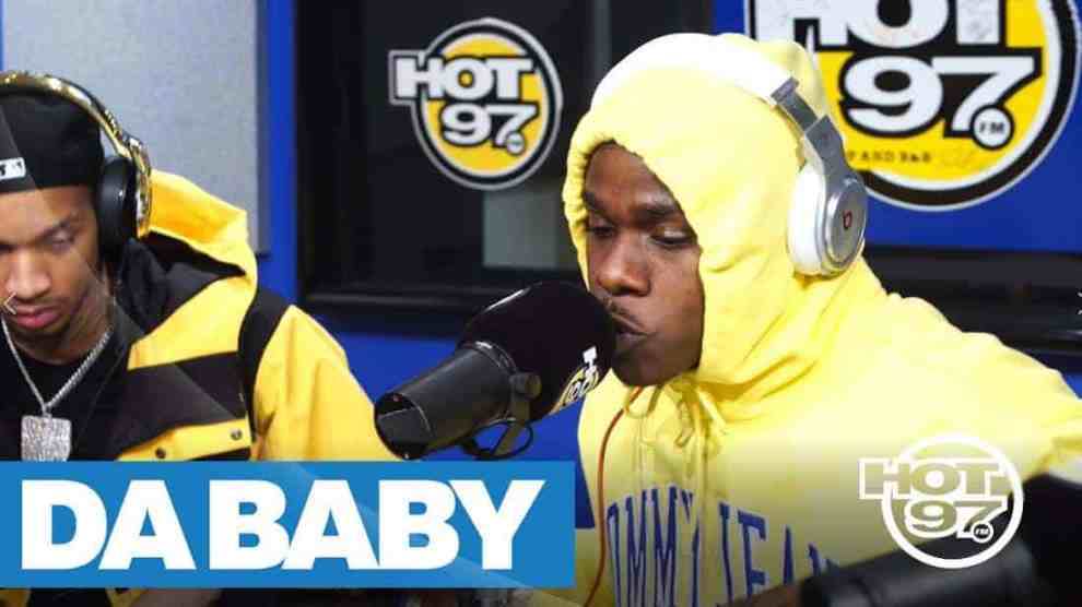 American rapper Da Baby with a Yellow hoodie tied around his face