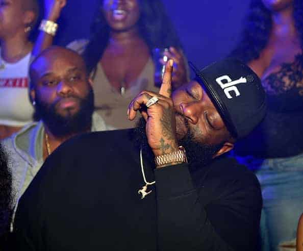 Rick ross pointing skyward