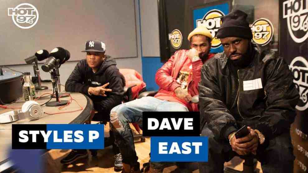 Funk Flex in a Black Jacket with a Hat on Next to Rapper Dave East in Red Jacket holding his hand over his face next to Rapper P