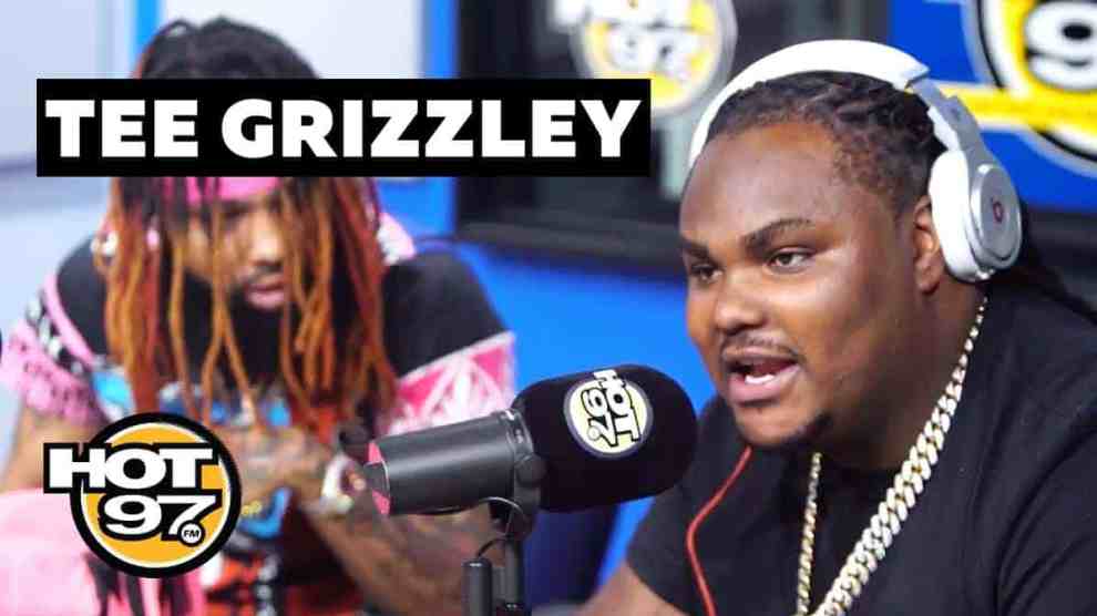 American Rappers Tee Grizzley at the microphone and Soda Baby looking at Tee Grizzley