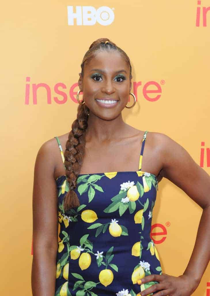 Issa Rae wearing a black dress and smiling