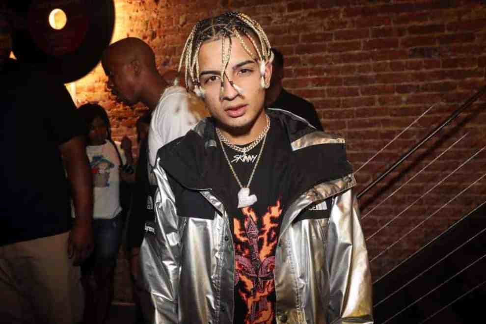 Skinnyfromthe9 wearing a silver jacket