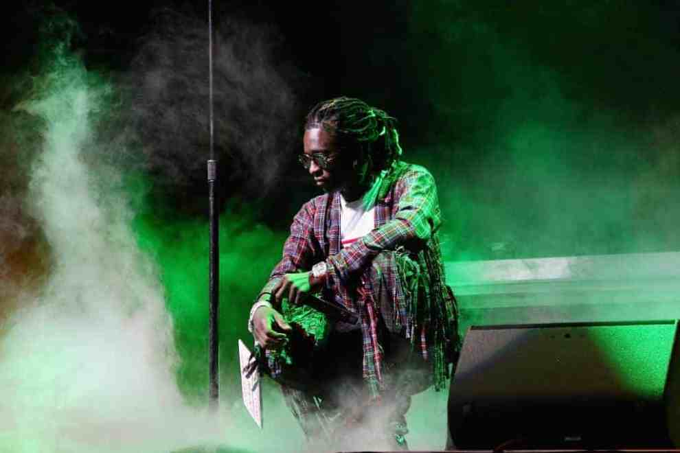 Young Thug performing in green smoke