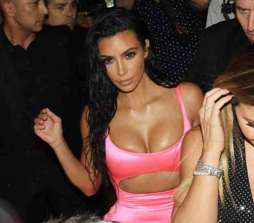 Kim Kardashian in neon pink cutout dress in a crowd