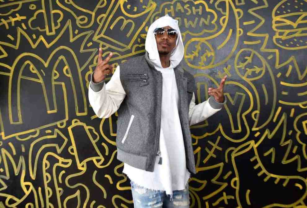 Nick Cannon in front of wall of McDonald's graffiti