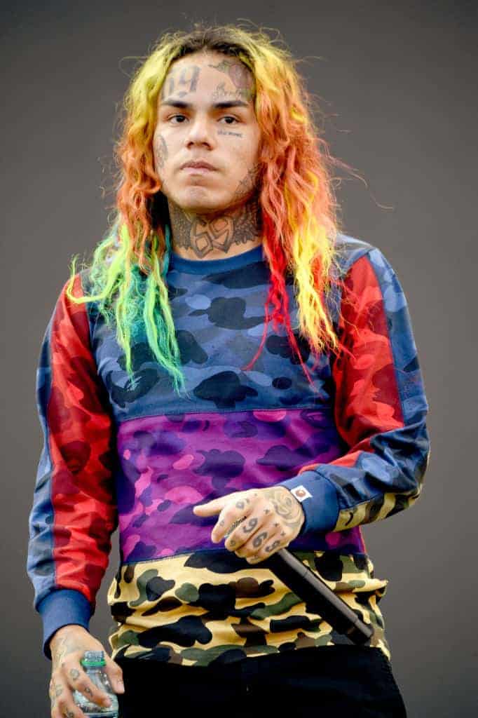 Tekashi 6ix9ine wearing a rainbow colored shirt