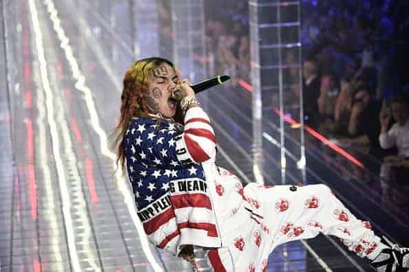 Tekashi 6ix9ine performing in red white and blue