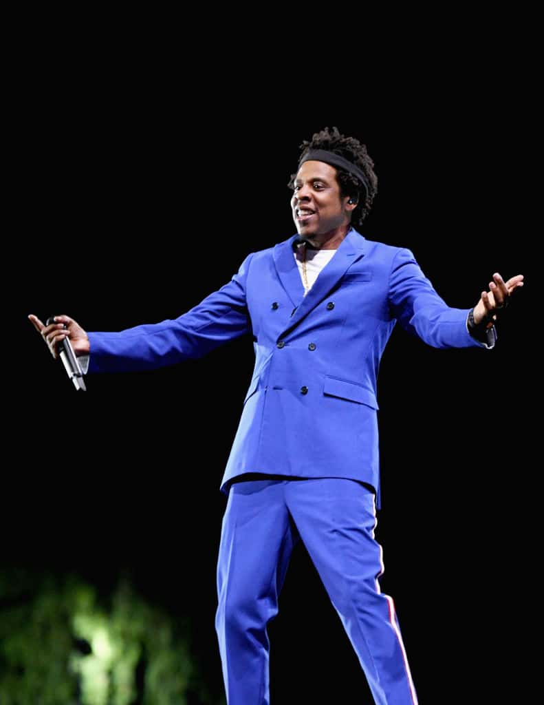 Jay Z wearing a blue suit on stage